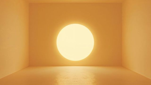 Minimalist amber chamber featuring glowing circular light and reflective shiny floor