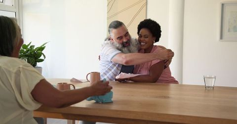 Senior couple joyful gift exchange celebrating at home