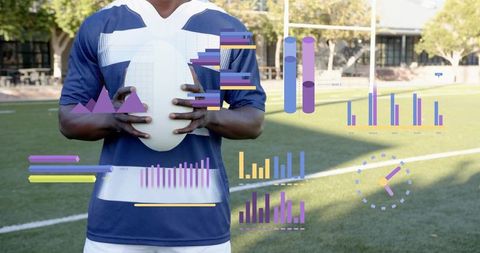 Athlete holding football on turf with augmented reality performance charts overlaying field