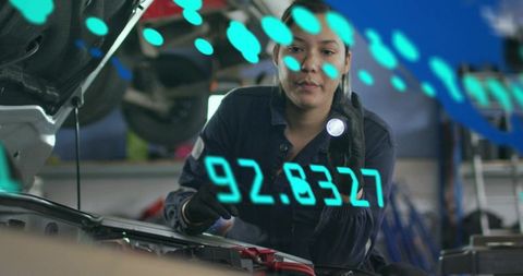 Female mechanic inspecting car engine with holographic ar diagnostics overlay