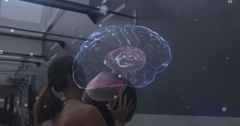 Female Athlete Performing Wall Ball with Medicine Ball and 3D Brain Hologram in Gym