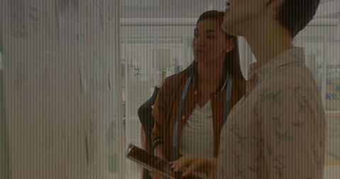 Designers Collaborating on Project in Modern Studio