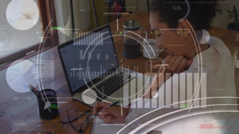 Businesswoman Analyzing Data on Laptop at Workspace