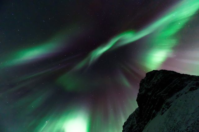 Stunning Aurora Borealis Dance in Night Sky Over Snowy Mountain - Download Free Stock Photos Pikwizard.com