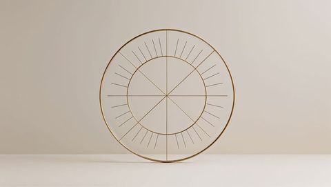Minimalist gold metallic ring sculpture in contemporary gallery