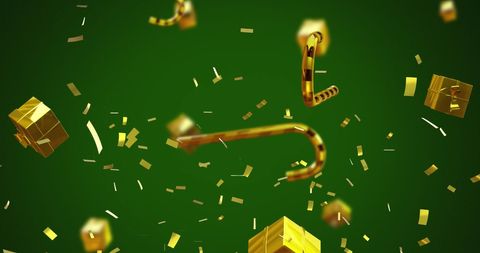 Golden christmas presents and candy canes on green background
