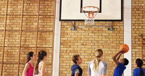 Teens Enjoying Basketball Game Indoors