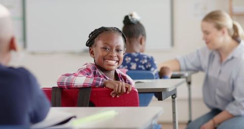 Smiling student in diverse classroom learning environment