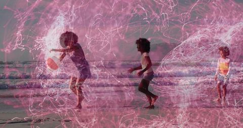 African american family playing on wet sand with bouncing beach ball and pink light trails