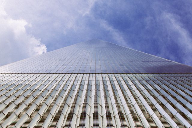 Upward View of Modern Skyscraper with Glass Facade and Cloudy Sky - Download Free Stock Photos Pikwizard.com