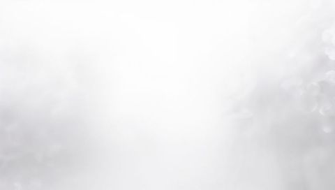 Minimal Soft Gray Gradient Backdrop Featuring Central Glow and Subtle Bokeh Haze