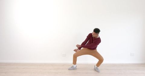 Energetic Man Dancing in Living Room Expressing Joy and Creativity