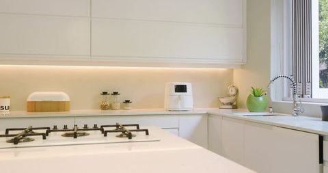Modern minimal kitchen with quartz island and appliances