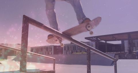 Skateboarder grinding rail in urban skatepark