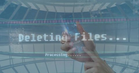 Hands holding smartphone displaying holographic HUD deleting files in futuristic glass atrium