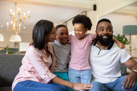 Joyful Family Bonding on Couch in Contemporary Living Room