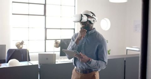 Businessman Engaged in Virtual Reality Experience Holding Tablet