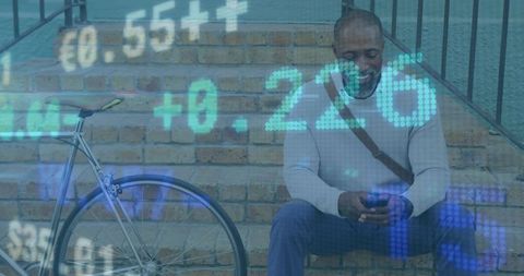 Urban professional sitting with technology and bicycle