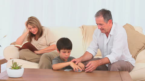 Grandfather Sharing Passion for Cards with Grandson at Home