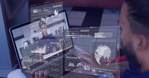 Bearded man working on laptop with augmented analytics dashboards and remote collaboration