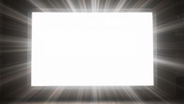 Luminous cinema screen emitting radial light beams on dark theater stage presentation mockup