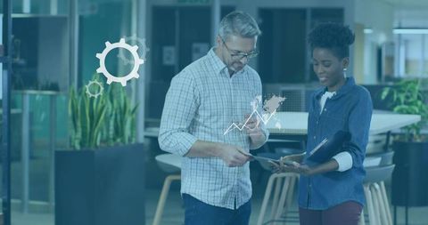 Colleagues Reviewing Work in Modern Office Environment with Data Overlay