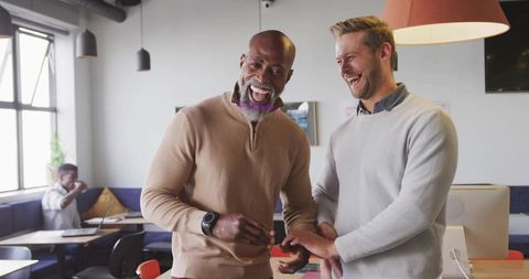 Colleagues Sharing a Congratulatory Moment in Modern Office Space
