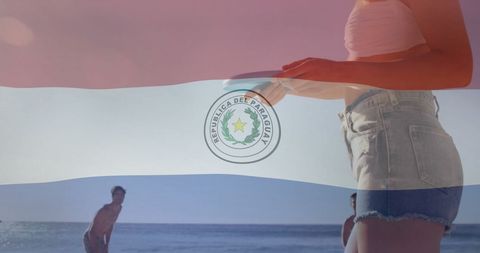 Paraguay flag overlay on people enjoying beach activities
