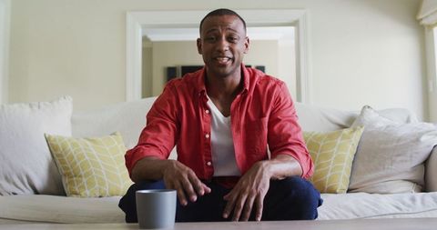 Smiling Man Having Video Call Seated on Cozy Sofa