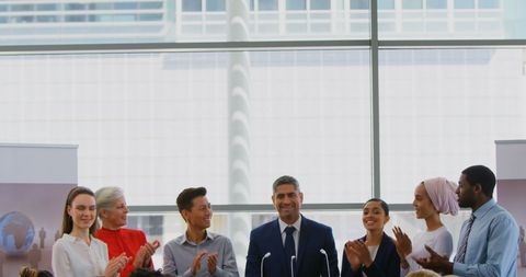 Diverse Business Team Applauding Leader at Seminar