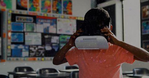 Student wearing vr headset in classroom with educational posters