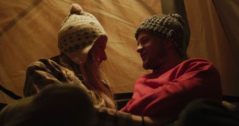 Caucasian Couple Relaxing Inside Tent During Camping Trip
