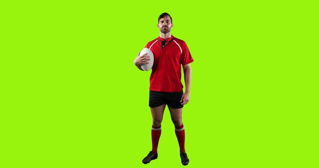 Rugby Player Posing With Ball Against Green Background - Download Free Stock Images Pikwizard.com