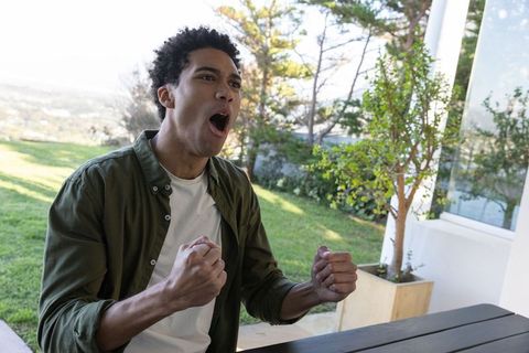 Excited Man Celebrating Outdoors with Clenched Fists