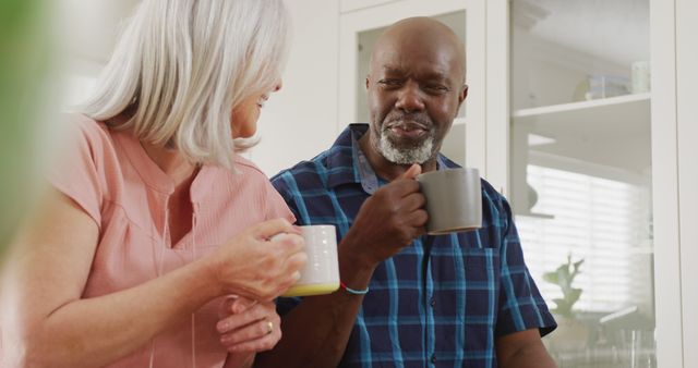 Senior Mixed Race Couple Drinking Coffee and Chatting in Kitchen - Download Free Stock Images Pikwizard.com