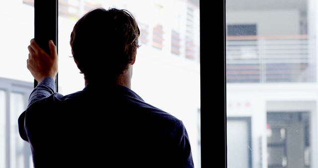 Man Looking Through Large Window at Modern Indoor Space - Download Free Stock Images Pikwizard.com