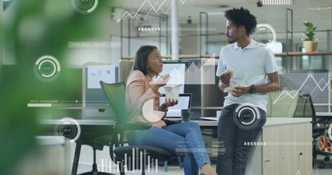 Diverse Colleagues Analyzing Data in Modern Office Space