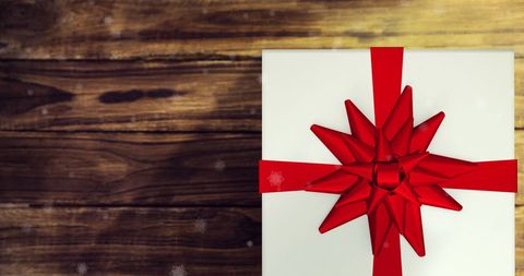 Red Bow Adorns Christmas Gift on Wooden Table - Download Free Stock Images Pikwizard.com