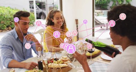 Friends Pouring Wine and Sharing Charcuterie Board at Bright Home Dinner Party