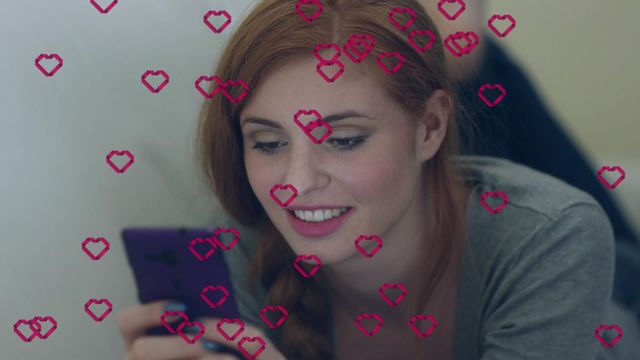 Smiling woman interacts with smartphone, surrounded by red heart icons, representing social media engagement and connectivity. Ideal for illustrating themes of digital communication, online interactions, and modern technology usage.