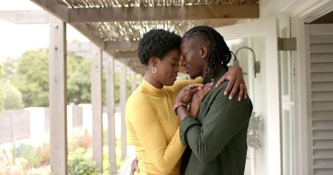 Romantic african american couple embracing on cozy porch