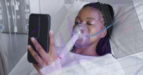 Patient using smartphone while receiving oxygen therapy with bedside monitor and telehealth