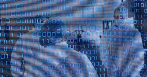 Medical team walking wearing ppe under digital binary overlay representing health tech