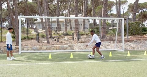 Youth Soccer Players Practicing Dribbling On Turf Field