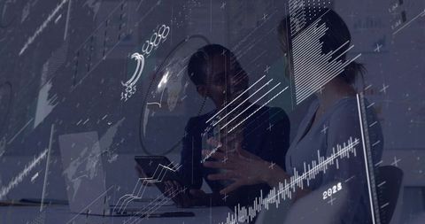 Businesswomen Collaborating and Analyzing Digital Data with Futuristic Analytics Overlay