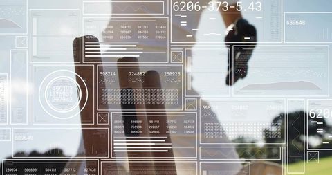 Corporate executive analyzing holographic data panels by window for finance analytics