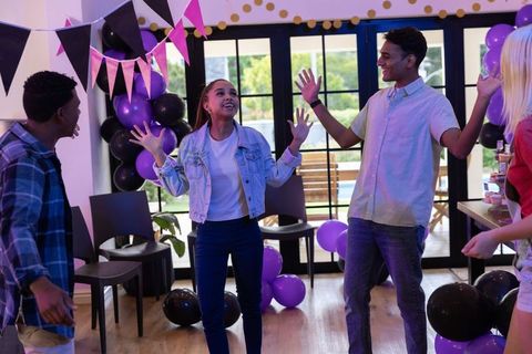 Teen Friends Celebrating at Vibrant Party with Balloons and Snacks