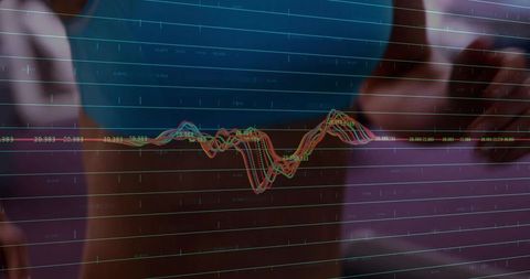 Female analyst touching glass display showing multicolor waveform data visualization