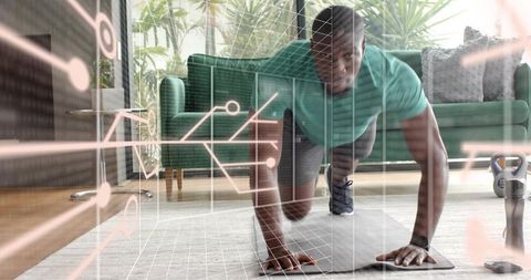 Man performing mountain-climber on mat with kettlebell in modern plant-filled living room