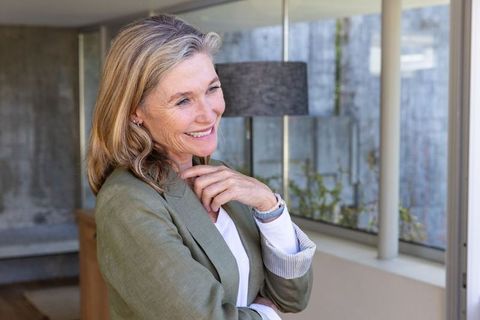 Senior woman standing confidently in modern office interior